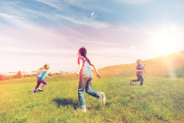 group of happy kids running outdoors