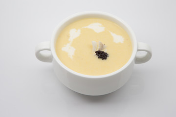 Corn soup with sprinkled Caviar in a white cup