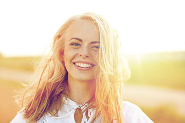 close up of happy young woman in white outdoors