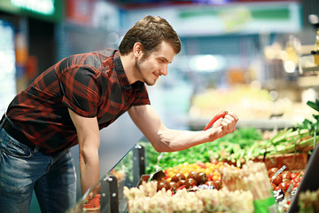 A young man shopping for fruit and veg