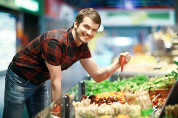 A young man shopping for fruit and veg
