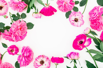 Round frame of pink roses and leaves on white background. Flat lay, top view.