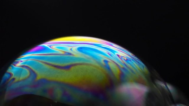 motion of soap bubble reflection in black background