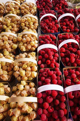 Locally grown, fresh, raspberries and physalis at market.