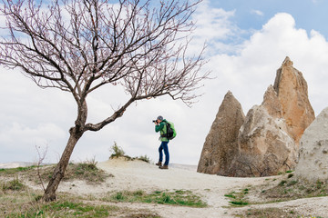  taking photos of rocky mountain landscape in Cappadocia