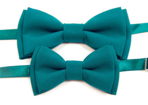 Green bow tie lies on a white table, two bow ties, tie green. Mens Tie, for groom and his younger brother