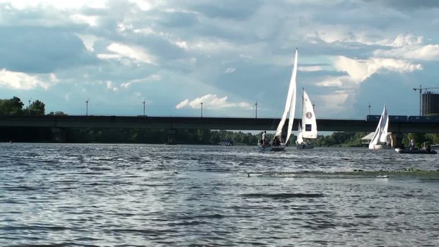 Sailboats sail along the river Dnieper near the Metro bridge. Kiev, Ukraine. HD 1920x1080 Video Clip