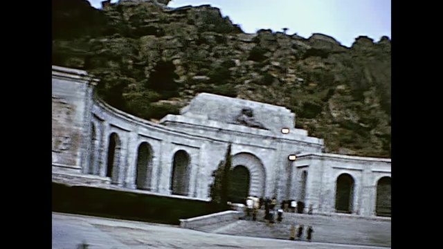 Panorama of the square in the Valle de los Caidos catholic basilica and monumental memorial in San Lorenzo de El Escorial near Madrid in Spain. Restored historical 70s archival footage on 1978.