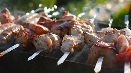 Barbecue Delicious Meat Cooked on the grill. A barbecue party. Pork pieces of meat roasted on an open fire