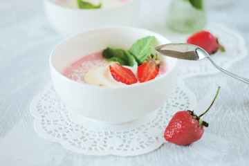 Cold creamy strawberry soup with a scoop of ice cream and mint
