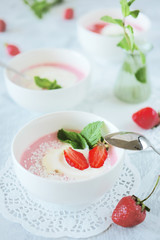 Cold creamy strawberry soup with a scoop of ice cream and mint