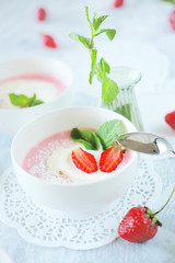 Cold creamy strawberry soup with a scoop of ice cream and mint
