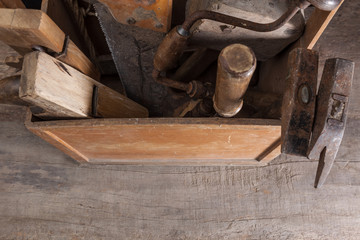 vintage carpenter toolbox with saw, hammer, planer, beater and twist drill