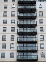Fototapeta premium Modern residential nuilding with white cladding and balconies
