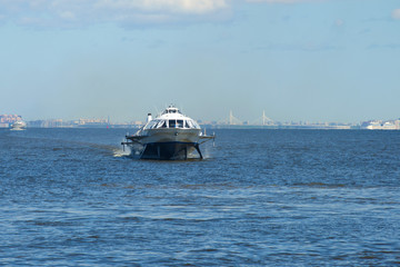 Fototapeta na wymiar The hydrofoil boat travels along the Gulf of Finland on a sunny May day, Saint-Petersburg