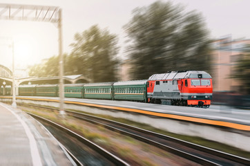 Fototapeta premium Modern diesel train with a passenger train departs from the station.