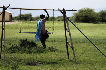 Masai girl on swing