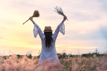 Woman in meadow. travel and sunset, soft and select focus