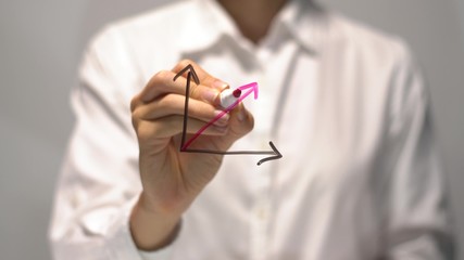 Woman drawing Substantial Growth diagram with red up arrow on transparent screen