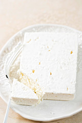 Fresh feta with salt on the plate 