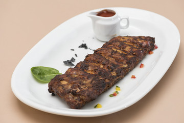  Grilled rib pork with barbecue sauce, placed on white plate, light background, isolated