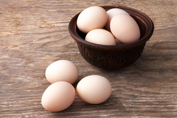 Hen eggs on wooden table. Fresh farmer's egg