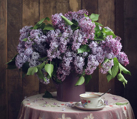 Bouquet of lilac on wooden background.