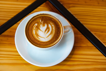 Cappuccino coffee cup on brown wood table background
