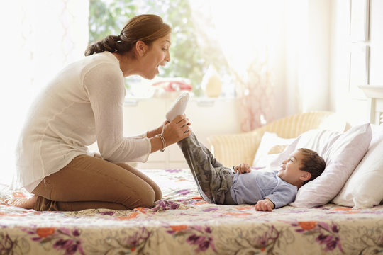 Mother Playing With Son (2-3) On Bed