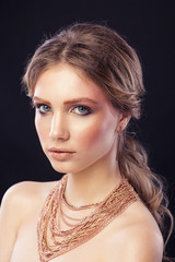 Fashion portrait model girl, with a many golden chains