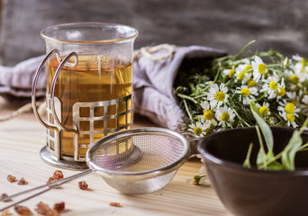 Chamomile  tea and flawer on the table.