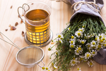 Chamomile  tea and flower on the table.