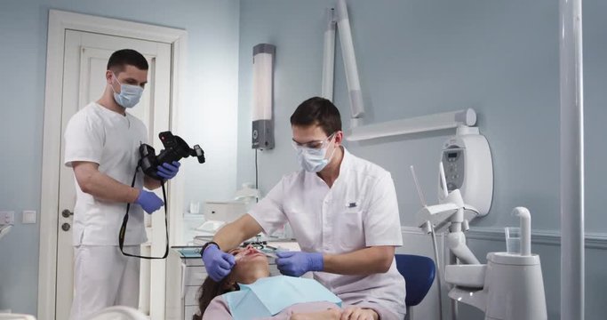 The modern dental office. The treatment of a patient using equipment of high technology