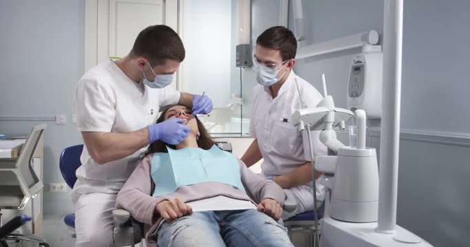 Examination of the oral cavity of a patient by a dentist in a modern dental office