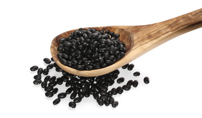 pile organic black beans with wooden spoon, isolated on white background