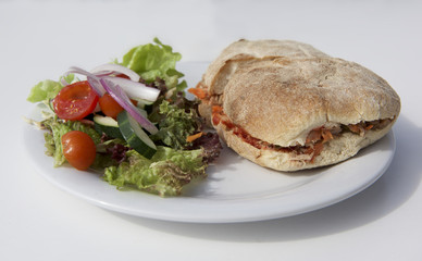 Maltese snack ftira isolated in white background served with fresh vegetable. Maltese ftira