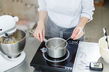 Woman in white uniform prepares food