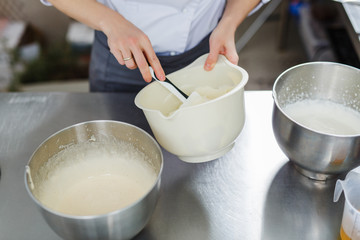 Woman in white uniform prepares food