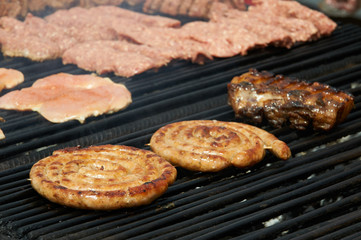 Sausages and meat on the grill.