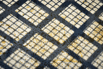 grid shadow on concrete
