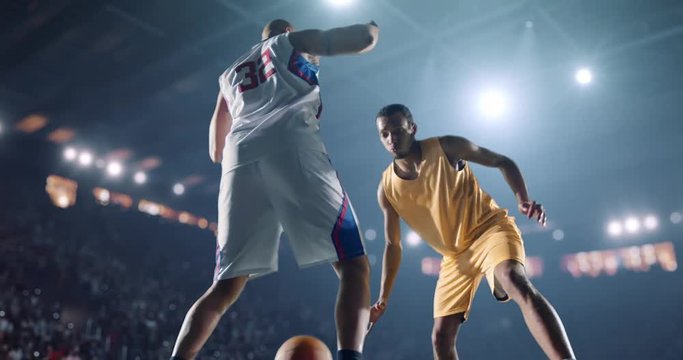 4K footage in slow motion basketball player dribbling in front of rival player. The action takes place in 3d made basketball arena full of spectators. All players wear unbranded basketball uniform.