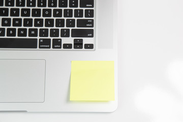 blank post it notes on laptop. Empty yellow adhesive paper on laptop keyboard 