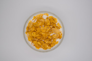 Top view cereal and milk in bowl on white background