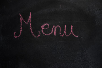 Red menu word drawn with chalk on blackboard
