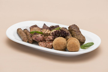 Traditional Romanian food plateau, with sausages, grilled meat, sweetbreads, potatoes, pickles, mustard, polenta, mushrooms, mici and vegetable salad, decorated with herbs, isolated on light backgroun