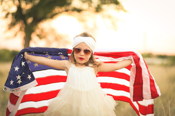 Adorable patriotic girl with american flag