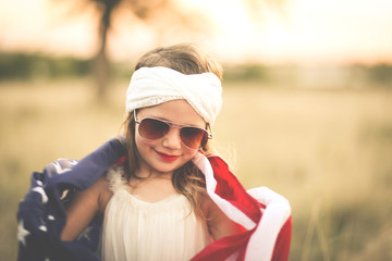 Adorable patriotic girl with american flag