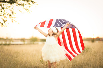 Adorable patriotic girl with american flag