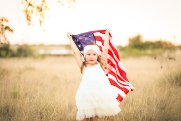 Adorable patriotic girl with american flag