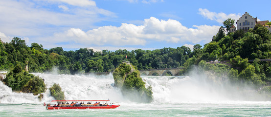 Boat with tourists at Rhine falls, the biggest waterfalls of Europe, in Schaffhausen, Switzerland.